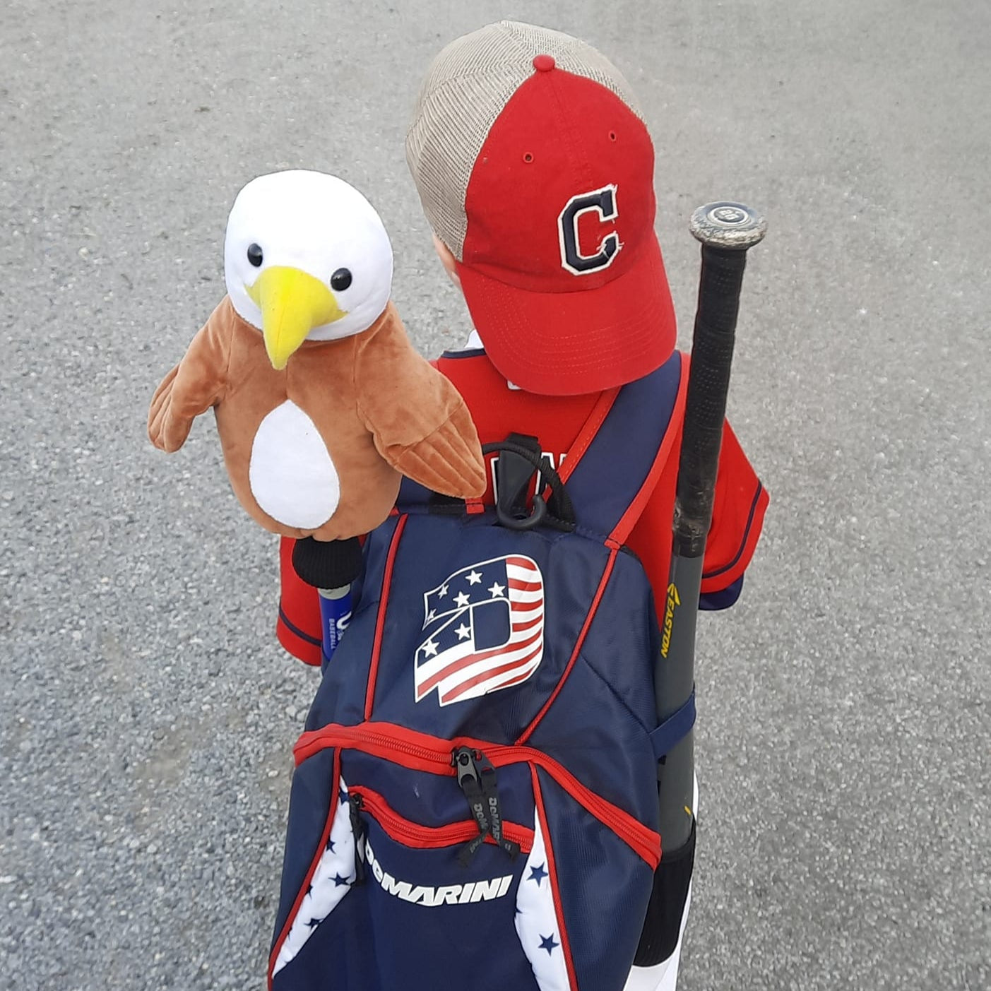 Young baseball player with Eagle Bat Hat bat cover